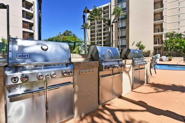 4327 Lower Honoapiilani Rd Unit 207B, Lahaina, HI 96761 - view of patio featuring exterior kitchen, grilling area, and a community pool