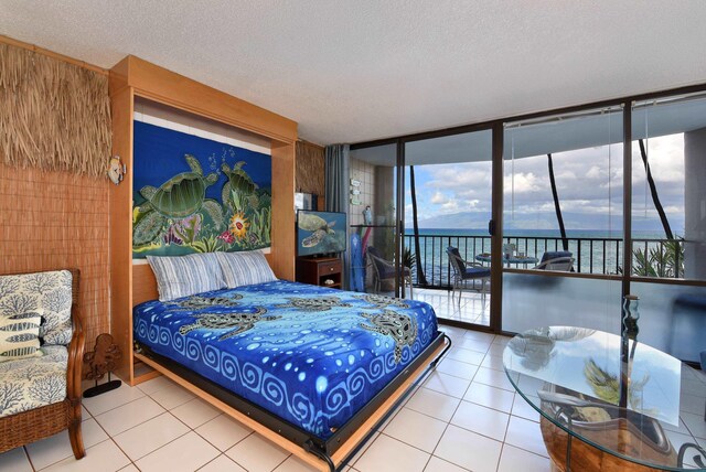 4327 Lower Honoapiilani Rd Unit 207B, Lahaina, HI 96761 - bedroom featuring a textured ceiling, tile patterned floors, and multiple windows