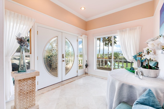 foyer featuring french doors and crown molding