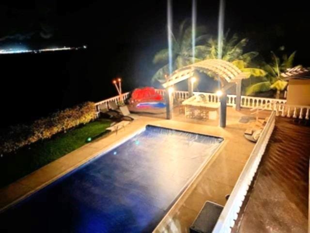 view of pool at night