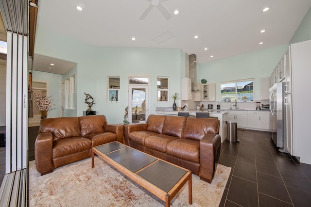 living room with tile patterned floors, ceiling fan, and sink