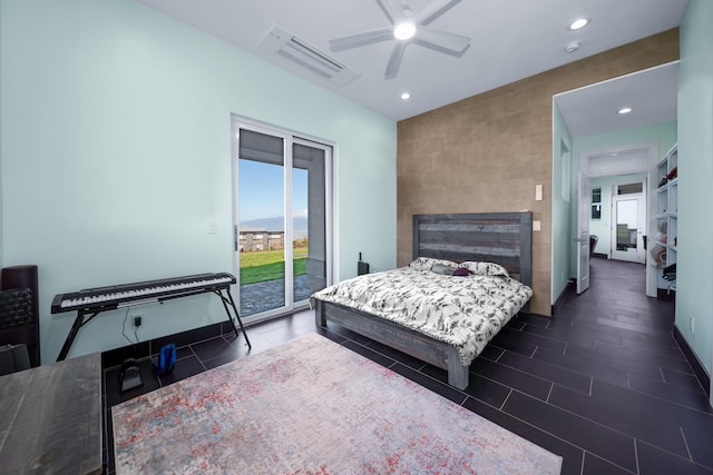 bedroom with ceiling fan, dark tile patterned floors, and access to outside