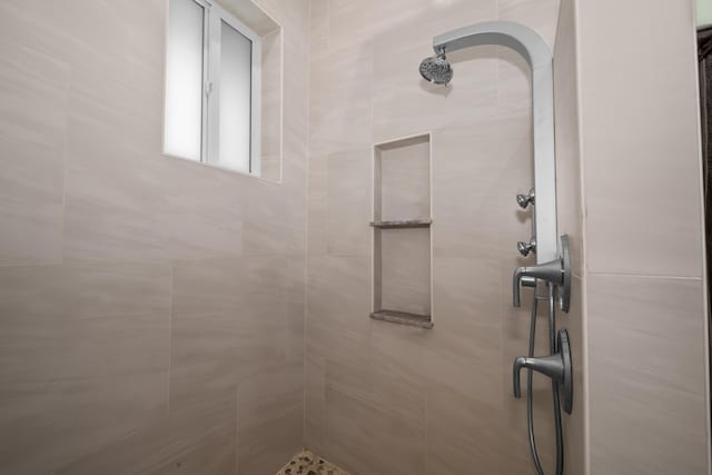 bathroom with tiled shower