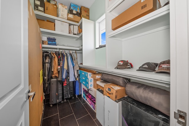 spacious closet featuring dark tile patterned floors