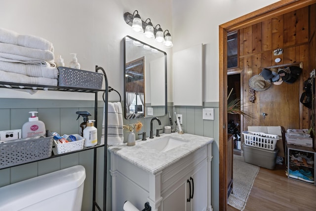 bathroom featuring vanity, toilet, and wood-type flooring