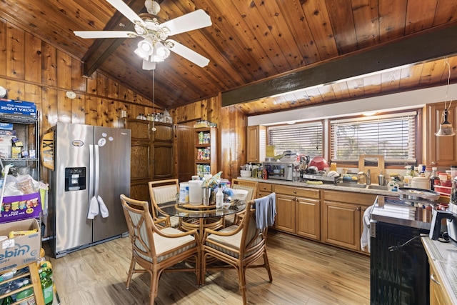 dining room with wood walls, light hardwood / wood-style flooring, and ceiling fan