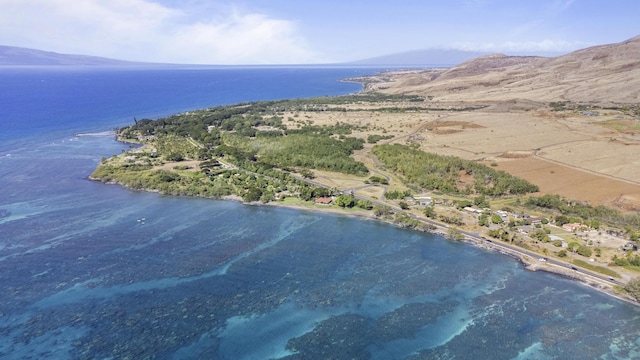 birds eye view of property with a water and mountain view