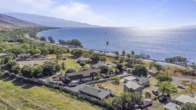 birds eye view of property with a water and mountain view