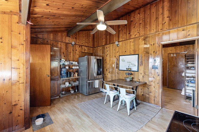 dining room with wooden ceiling, wooden walls, light hardwood / wood-style flooring, vaulted ceiling with beams, and ceiling fan