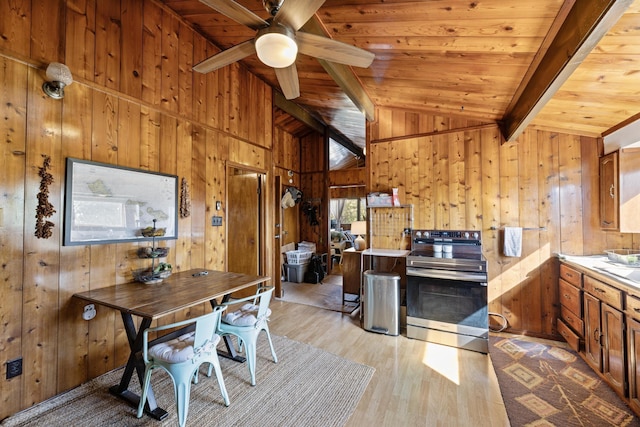 dining space featuring wood walls, light hardwood / wood-style flooring, and wood ceiling