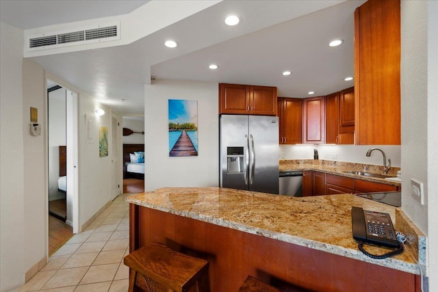 3445 Lower Honoapiilani Rd Unit 204, Lahaina, HI 96761 - kitchen with appliances with stainless steel finishes, a sink, a peninsula, light stone countertops, and recessed lighting