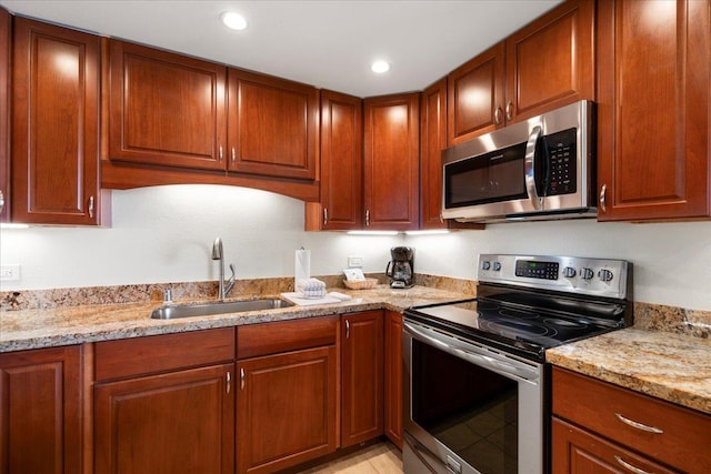 3445 Lower Honoapiilani Rd Unit 204, Lahaina, HI 96761 - kitchen with appliances with stainless steel finishes, a sink, light stone countertops, brown cabinets, and recessed lighting