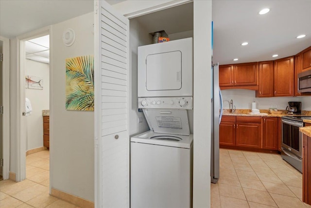 3445 Lower Honoapiilani Rd Unit 204, Lahaina, HI 96761 - laundry room with stacked washer and clothes dryer, light tile patterned flooring, recessed lighting, and baseboards