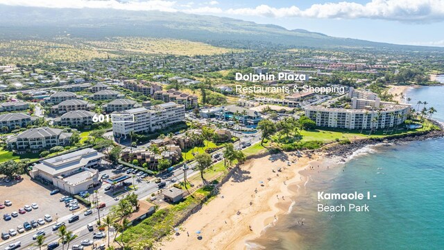 drone / aerial view featuring a water view and a beach view