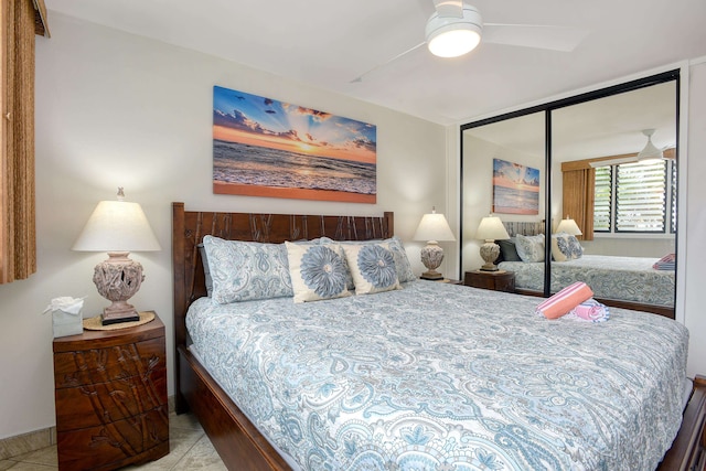 tiled bedroom featuring a closet and ceiling fan