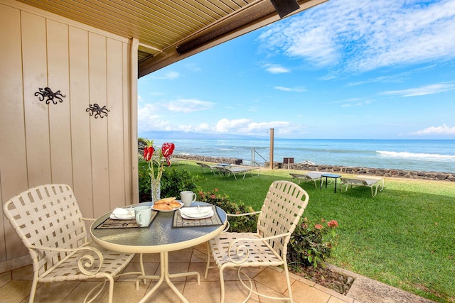 balcony featuring a water view and a patio