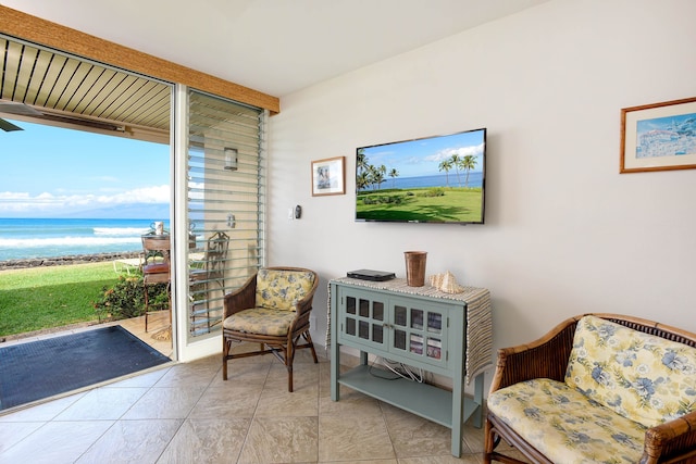 living area featuring a water view and light tile floors