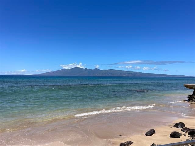 water view with a beach view and a mountain view