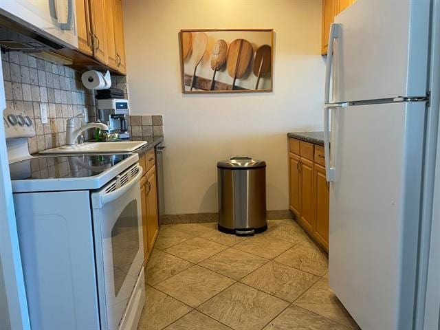 kitchen with sink, white appliances, backsplash, and light tile flooring