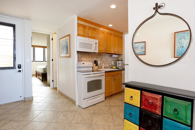 kitchen with tasteful backsplash, white appliances, and light tile floors