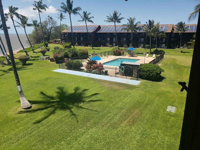 view of swimming pool featuring a lawn and a patio