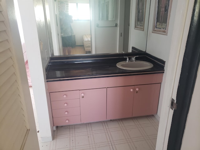 bathroom featuring large vanity and tile floors