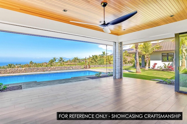 swimming pool featuring a ceiling fan, a patio area, and a yard