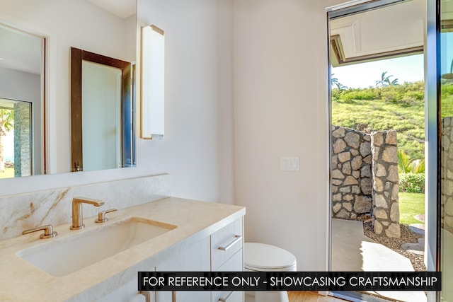 bathroom with vanity and toilet