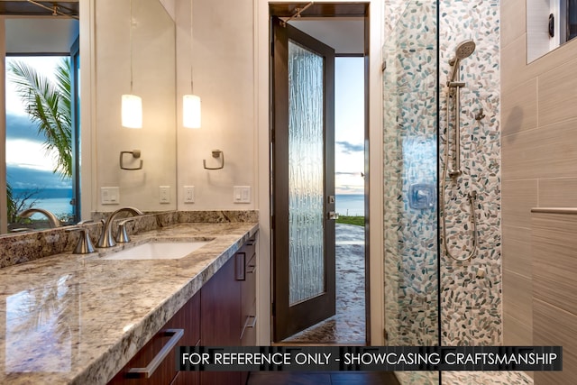 bathroom featuring vanity, a water view, and tiled shower