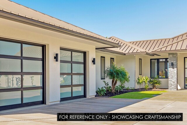 property entrance with stucco siding and metal roof