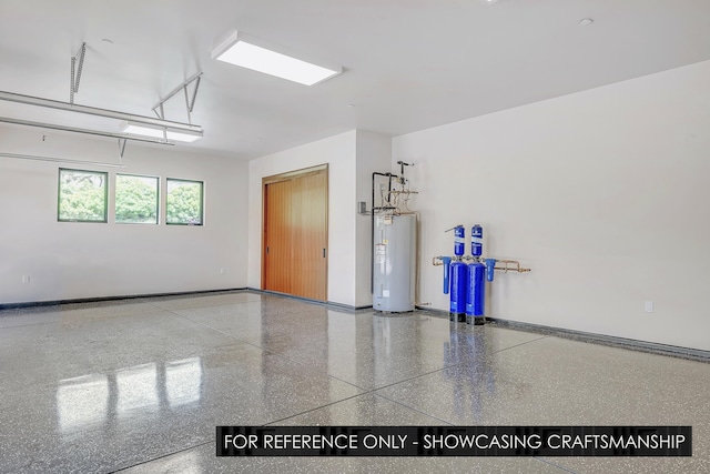 garage with electric water heater and baseboards