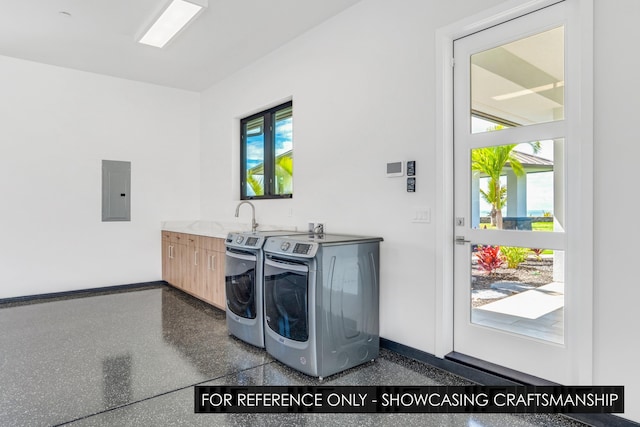 clothes washing area with washer and clothes dryer, electric panel, cabinet space, and baseboards