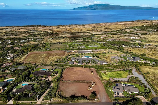 view of property location featuring a large body of water and nearby suburban area