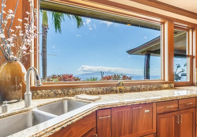 kitchen with light stone countertops and sink