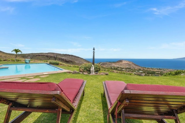 view of swimming pool featuring a water view and a yard