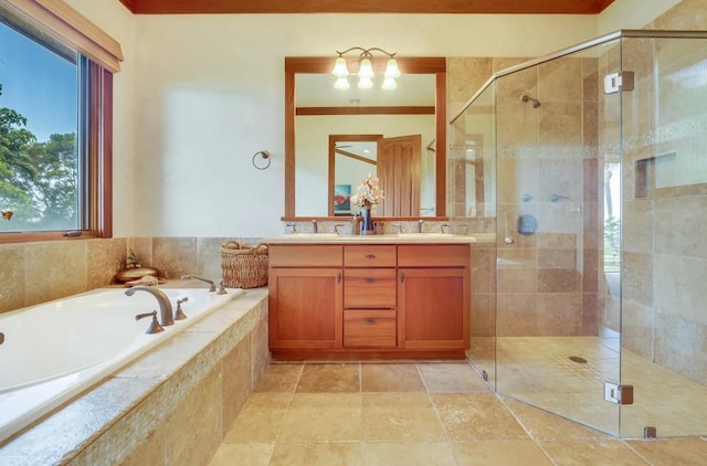 bathroom with vanity and independent shower and bath