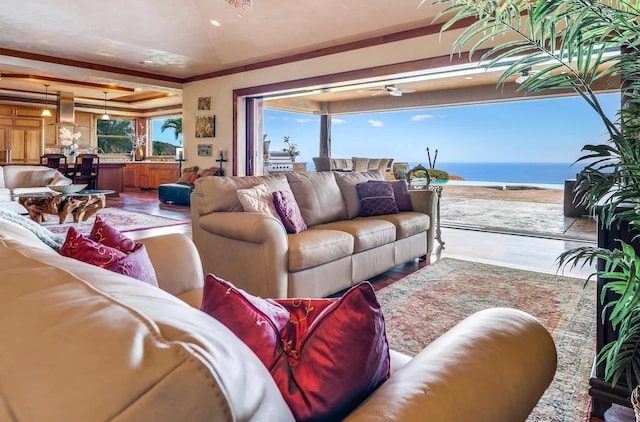 living room with wood-type flooring, crown molding, and a water view