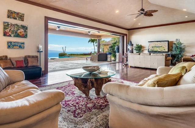 living room featuring plenty of natural light, dark hardwood / wood-style floors, ornamental molding, and lofted ceiling