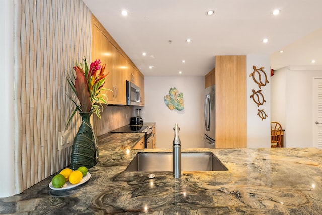 110 Kaanapali Shores Pl Unit 109, Lahaina, HI 96761 - kitchen featuring appliances with stainless steel finishes, stone counters, recessed lighting, and brown cabinets