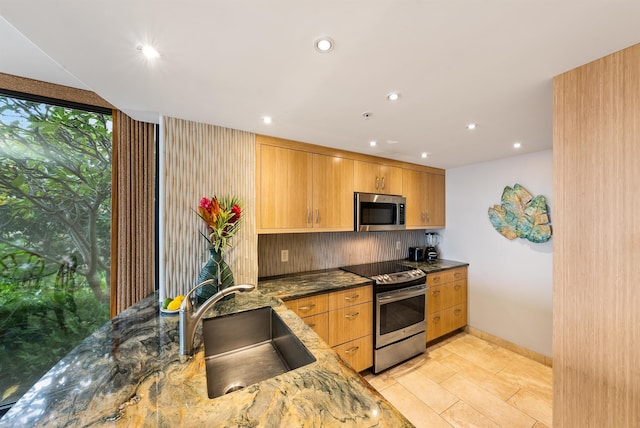 110 Kaanapali Shores Pl Unit 109, Lahaina, HI 96761 - kitchen with stainless steel appliances, dark stone counters, recessed lighting, and decorative backsplash