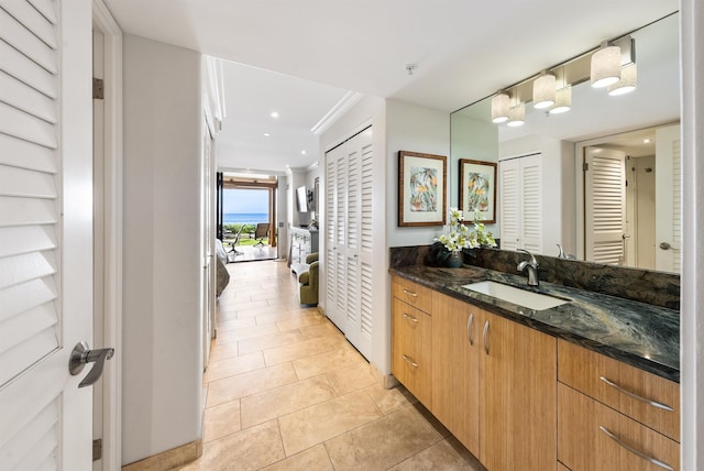 110 Kaanapali Shores Pl Unit 109, Lahaina, HI 96761 - bathroom with a closet, vanity, tile patterned floors, crown molding, and recessed lighting