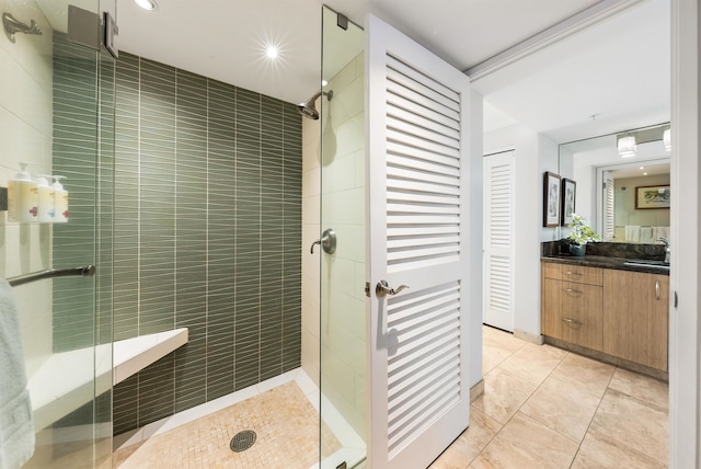 bathroom with vanity, tile patterned floors, and a shower with door