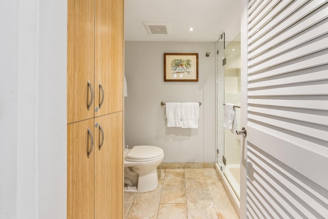 bathroom with tile patterned floors, toilet, and an enclosed shower