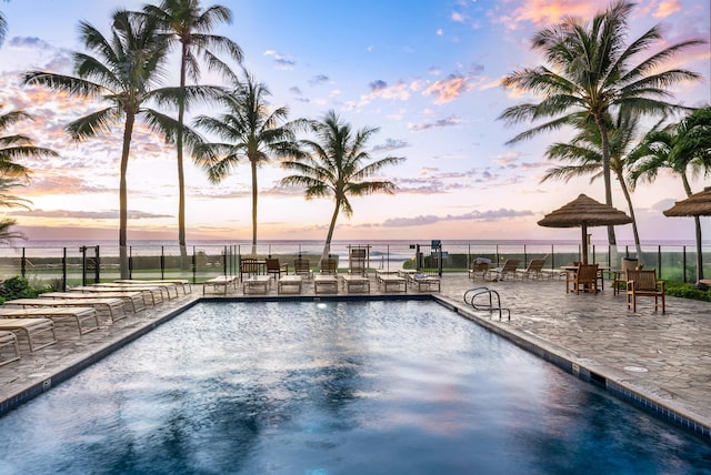 pool at dusk with a water view