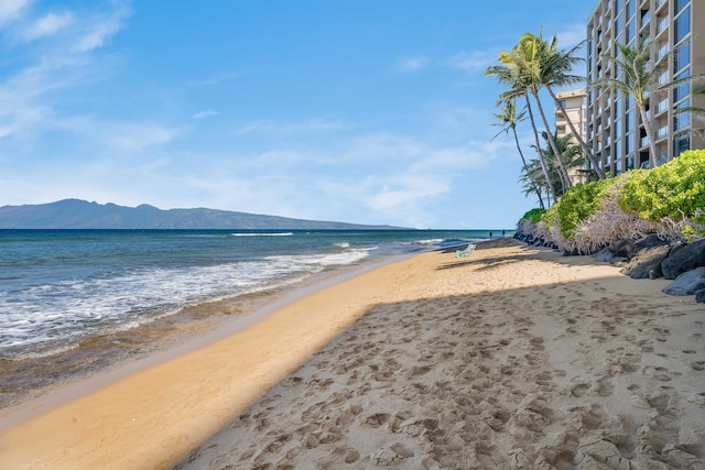 water view featuring a mountain view and a beach view