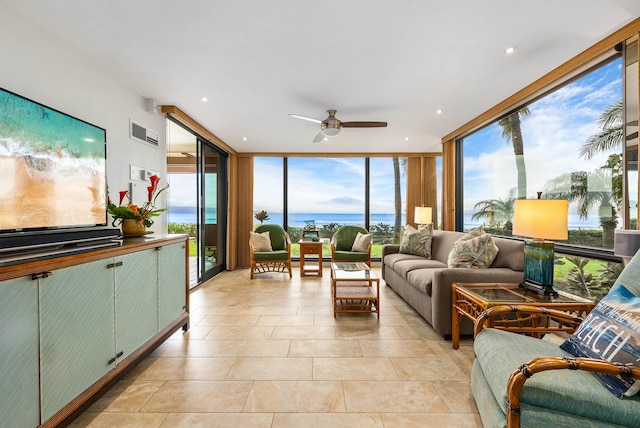 interior space featuring ceiling fan, a water view, and plenty of natural light