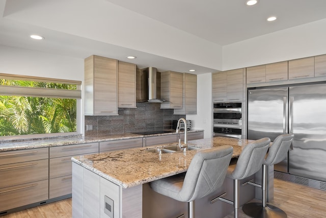 2274 S Kihei Rd, Kihei, HI 96753 - kitchen featuring stainless steel appliances, modern cabinets, wall chimney exhaust hood, recessed lighting, and a breakfast bar