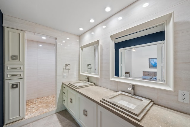2274 S Kihei Rd, Kihei, HI 96753 - ensuite bathroom with double vanity, backsplash, tiled shower, tile patterned flooring, and tile walls