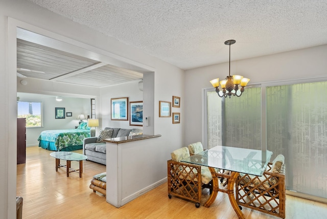2274 S Kihei Rd, Kihei, HI 96753 - dining space featuring a chandelier, light wood-style floors, and a textured ceiling