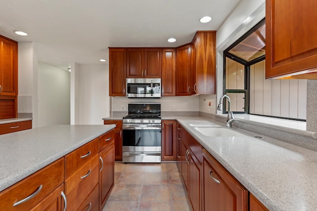 kitchen featuring light tile patterned floors, sink, and stainless steel appliances